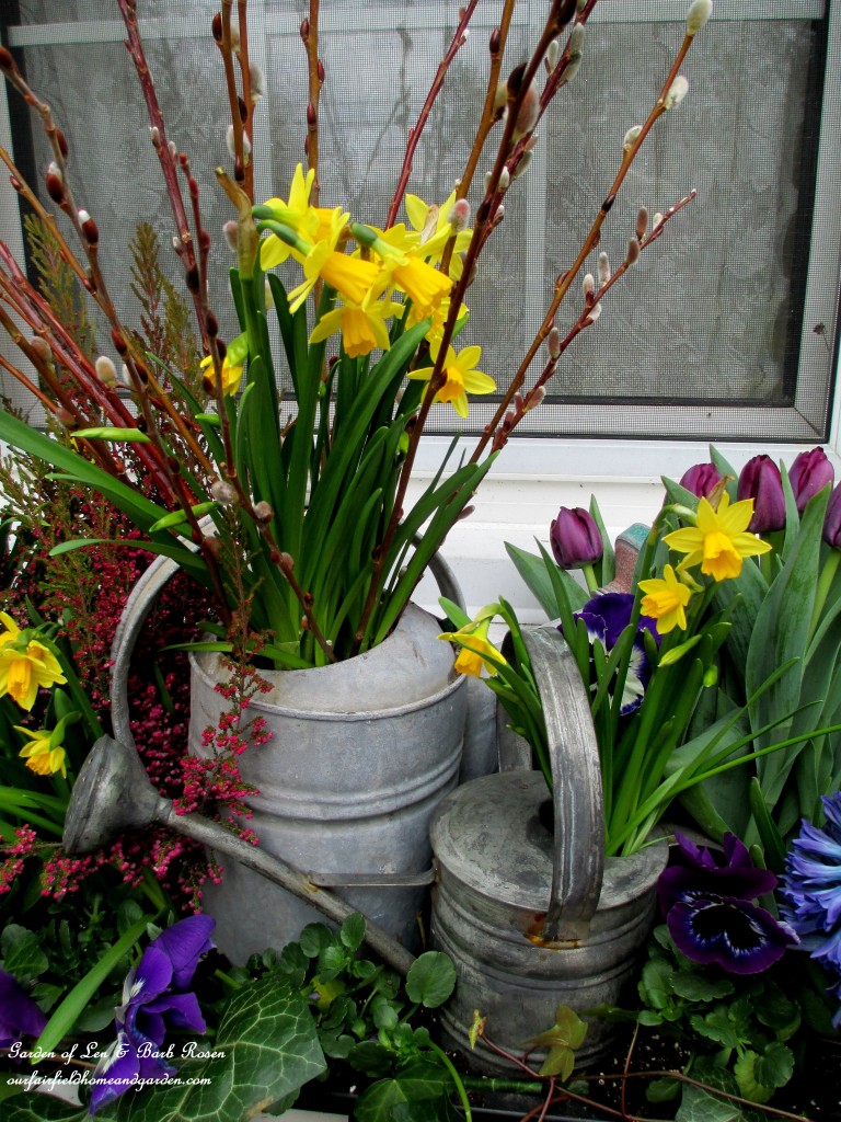 Close-up of the watering cans in the windowbox. https://lolajack.jp.net/diy-project-welcome-spring-time-to-change-the-window-boxes/