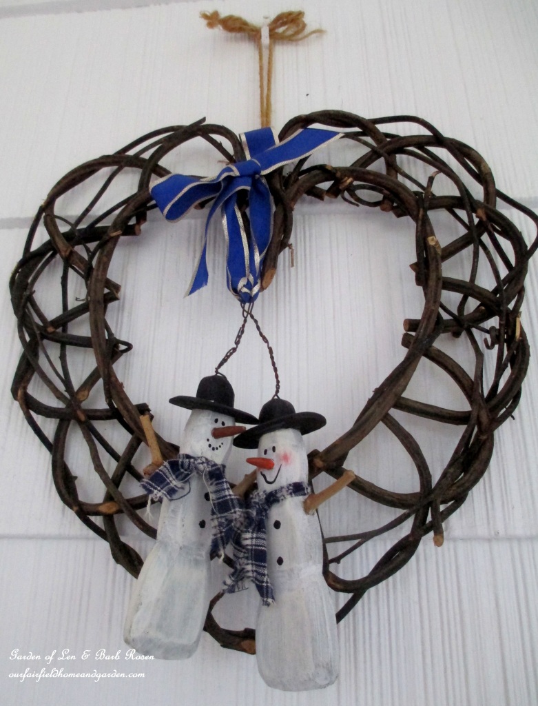 Snowman Wreath https://lolajack.jp.net/rustic-watering-cans-windowboxes-more/
